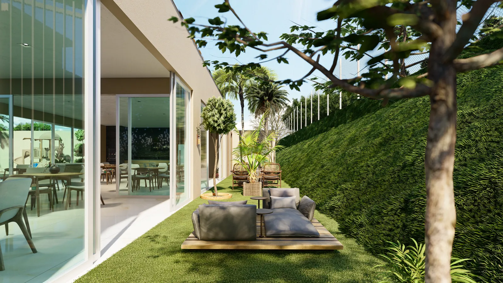 Lounge externo cercado de verde