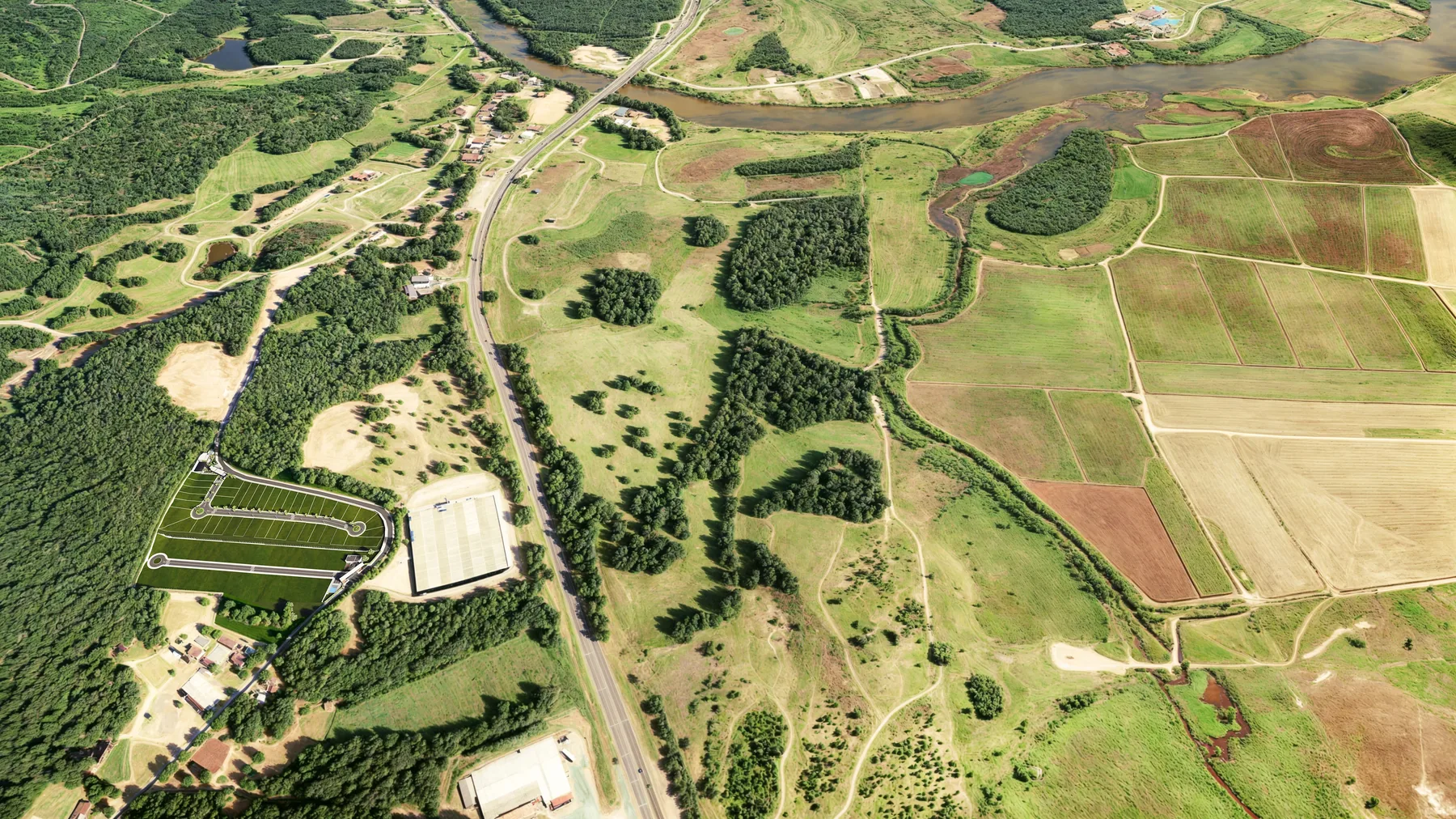 Vista aérea da região do Escalvado, com o relevo verde, o rio, a BR-101 e a área do First Reserva à esquerda