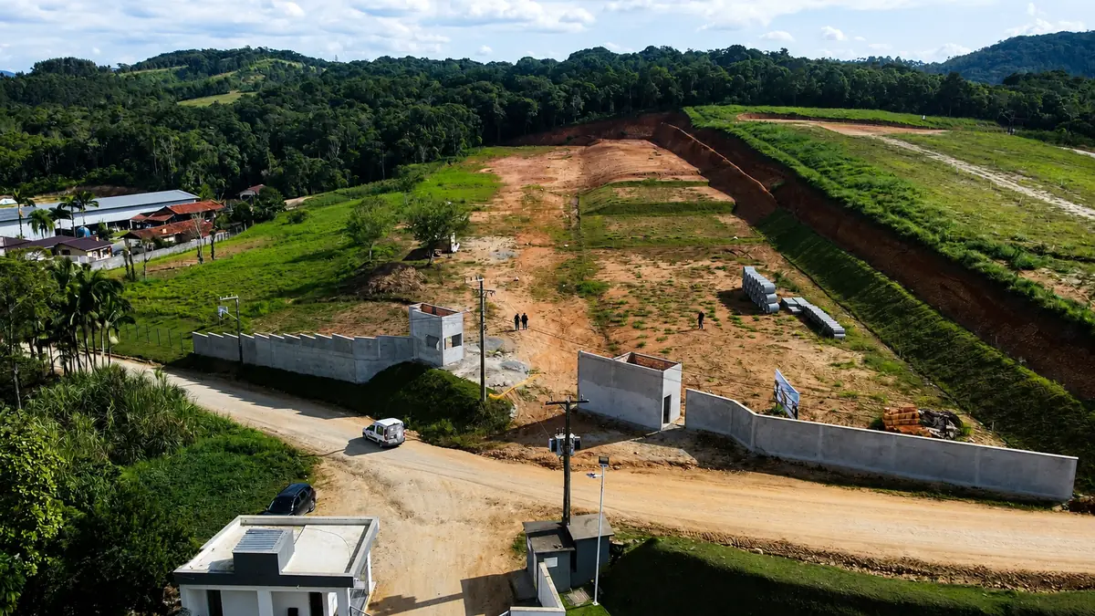 Vista aérea da portaria e do muro de divisa, com a gleba terraplanada ao fundo